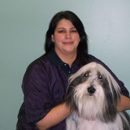 woman holding large white and black dog