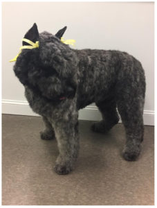 black dog with yellow ribbons on head