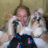 woman holding two terriers